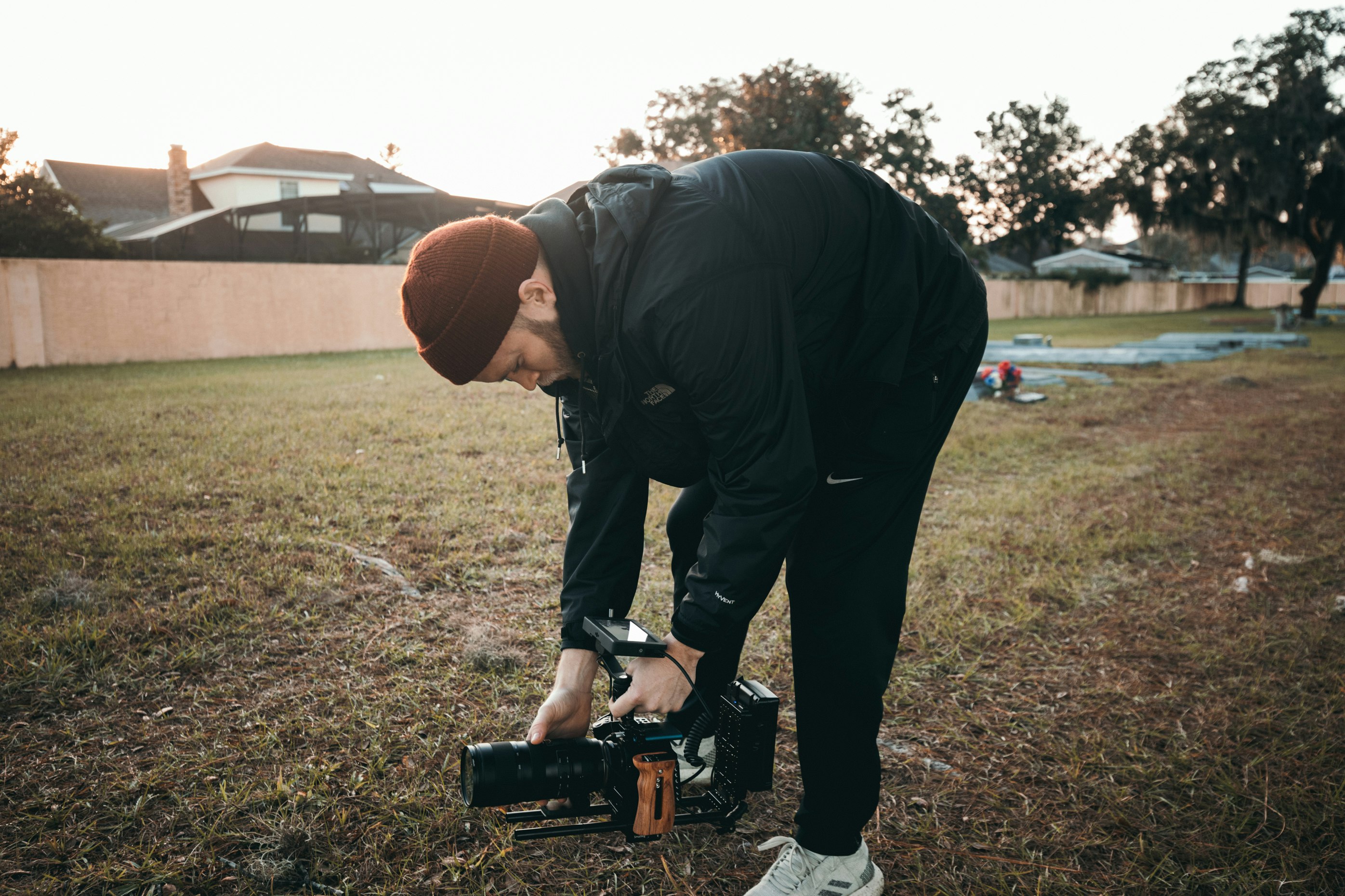 man wearing black jacket holding video camera